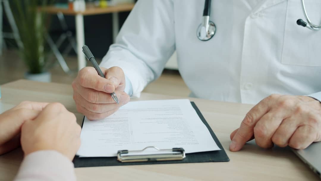 Weight Loss Clinic | BPC-157 Safety & Evidence: What Patients Should Know Physician reviewing medical history during an evidence-based consultation